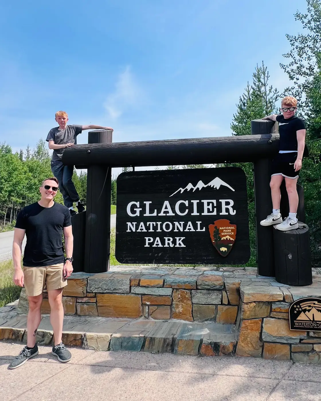 Tim, Jack, and Will at the Glacier National Park entrance sign