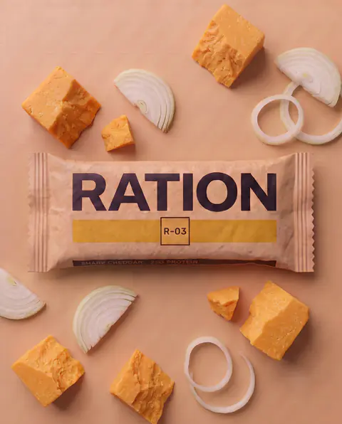 Studio render of the R-03 Sharp Cheddar bar in its printed wrapper.