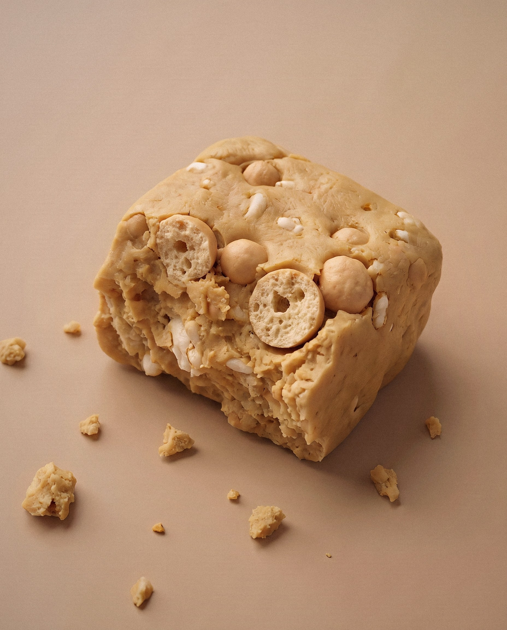 Studio render, close up: a Ration bar broken in half to show the interior, protein-bar filling packed with puffed rice and round protein crisps.