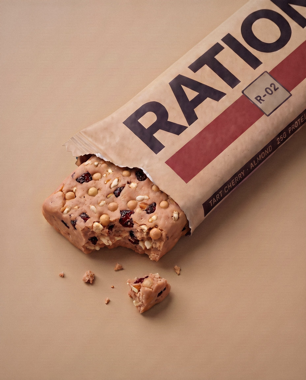 Studio render of the R-02 Tart Cherry · Almond bar peeking out of its torn-open printed wrapper: the flavor band color across the matte-paper pack, imperfect hand-pressed edges and a few crumbs on a neutral studio background.
